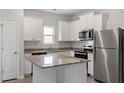 Kitchen featuring stainless steel appliances, granite countertops, and white cabinetry at 100 Flue Ct, Oxford, NC 27565