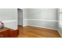 Light-filled, empty room with hardwood floors and white trim at 1003 Blackberry Ln, Durham, NC 27712