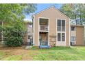 Two-story townhouse featuring neutral siding, balconies, and backyard in a serene setting at 1009 Iredell St # D, Durham, NC 27705