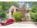Two-story townhouse shows neutral siding, balcony and ample parking in a serene wooded setting at 1009 Iredell St # D, Durham, NC 27705