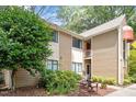 Exterior view of two-story townhouse featuring neutral siding, with private patio and lush landscaping at 1009 Iredell St # D, Durham, NC 27705