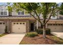 Charming townhome with a brick and siding exterior, two-car garage, and well-maintained landscaping at 1016 Kingston Grove Dr, Cary, NC 27519