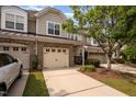 Charming townhome with a brick and siding exterior, two-car garage, and well-maintained landscaping at 1016 Kingston Grove Dr, Cary, NC 27519