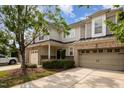 Charming townhome with a brick and siding exterior, two-car garage, and well-maintained landscaping at 1016 Kingston Grove Dr, Cary, NC 27519