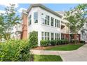 Side exterior showcasing many large windows, established shrubbery, and partial balcony at 10310 Sablewood Dr # 115, Raleigh, NC 27617