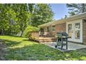 Backyard patio with outdoor seating and grill, perfect for entertaining with a large grassy area at 104 S Tunstall St, Apex, NC 27502