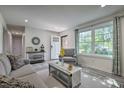 Bright living room with fresh decor, new flooring, and a large window for ample natural light at 104 S Tunstall St, Apex, NC 27502