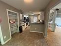 Functional kitchen features white cabinets, updated appliances, tile floors and an adjacent open living space at 10415 Neland, Raleigh, NC 27614