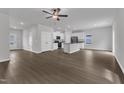 Open concept kitchen and living area featuring white cabinets, stainless steel appliances and wood-look floors at 106 Flue Ct, Oxford, NC 27565