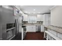 Modern kitchen featuring stainless steel appliances, granite counters and white cabinetry at 11 Willow Bridge Dr, Durham, NC 27707