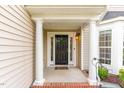 Welcoming front porch with classic columns, a dark wood door, and sidelights, enhancing curb appeal at 1108 Forest Willow Ln, Morrisville, NC 27560