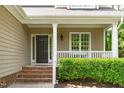 Inviting front porch with classic columns, trim, brick steps, and a view of the landscaped yard at 113 Chestone Ct, Cary, NC 27513
