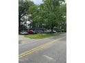 Quaint gray homes line a street, framed by mature trees and well-kept lawns at 12600 Old Stage Rd, Willow Springs, NC 27592