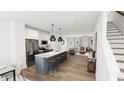 Open-concept kitchen featuring stainless steel appliances, and a large island at 1537 Piney Fls Dr, Wendell, NC 27591