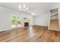 Bright living room featuring hardwood floors, a fireplace, and access to the back deck at 1547 Village Glenn Dr, Raleigh, NC 27612
