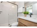 Modern bathroom featuring a glass-enclosed shower, wood vanity, and sleek fixtures at 1601 Merry Mdw Way, Wendell, NC 27591