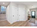 Inviting entryway with wood floors, neutral paint, and a green front door at 1601 Merry Mdw Way, Wendell, NC 27591