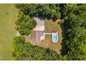 Aerial view of a home with a pool, surrounded by lush trees and green lawns at 1909 Ira Rd, Efland, NC 27243
