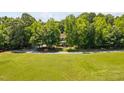 Expansive front yard leading to a house surrounded by trees and lush greenery at 1909 Ira Rd, Efland, NC 27243