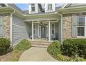 Inviting front porch with stone steps and decorative columns create a welcoming entrance at 21 Boots Dr, Angier, NC 27501