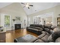 Bright living room with vaulted ceiling, fireplace, and large windows for natural light at 21 Boots Dr, Angier, NC 27501