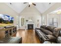 Spacious living room featuring vaulted ceilings, fireplace, and hardwood floors at 21 Boots Dr, Angier, NC 27501