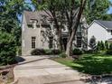 View of the home and driveway, highlighted by professional landscaping and mature trees at 2125 Pine Dr, Raleigh, NC 27608