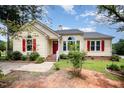 Charming single-Gathering home with a red front door and beautiful landscaped yard at 220 Needle Park Dr, Cary, NC 27513