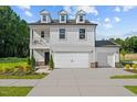 Charming two-story home boasts a welcoming front porch, attached garage, and beautifully landscaped yard at 222 Faith Avenue, Sanford, NC 27330