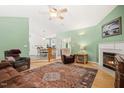 Inviting living room featuring a fireplace, hardwood floors, and a comfortable seating area with natural light at 229 White Oak Farm Dr, Willow Springs, NC 27592