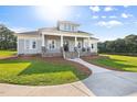 Inviting front porch with stone accents, white columns, and a lake view at 2493 Nc-242, Benson, NC 27504