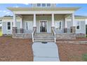 Charming front porch with stone details, white columns, and easy entry at 2493 Nc-242, Benson, NC 27504