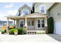 Inviting front porch with detailed trim, brick accents, and beautiful landscaping at 25 Ruth Cir, Fuquay Varina, NC 27526