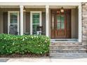Inviting front porch with rocking chairs and a decorative flower bush at 3021 Lawson Walk Way, Rolesville, NC 27571