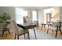 Well-lit home office featuring hardwood floors, elegant furniture, and serene atmosphere at 304 Ramblewood Dr, Raleigh, NC 27609