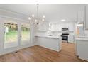 Bright kitchen features white cabinets, stainless appliances, and a door to the backyard at 3129 Merrianne Dr, Raleigh, NC 27607