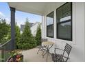 Charming front porch with table and chairs offering a cozy outdoor seating area with decorative planters at 3829 Sleepy Brook Ln, Apex, NC 27539