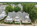 Aerial view of the townhome community with lush green trees and well-maintained exteriors at 3902 Stags Leap Cir, Raleigh, NC 27612