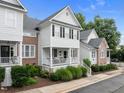 Two-story townhome with a covered front porch, showcasing the architectural details and landscaping at 3902 Stags Leap Cir, Raleigh, NC 27612