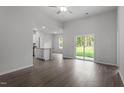 Open-concept living area with wood-look floors and sliding glass doors to backyard at 405 Benton Dr, Oxford, NC 27565