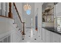 Elegant foyer with marble floors, chandelier, and a grand staircase leading to the upper level at 4315 Sugar Pine Ln, Durham, NC 27705