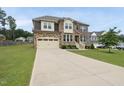 Two-story home with a stone and vinyl exterior, showcasing a spacious driveway and well-maintained lawn at 433 Village Bend Dr, Fuquay Varina, NC 27526