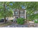 Charming two-story home with a well-maintained front yard and a classic facade, showcasing its inviting curb appeal at 4825 Windbreak Ln, Raleigh, NC 27616