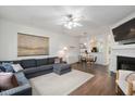 Cozy living room with a fireplace, comfortable seating, and a seamless flow into the dining area at 4826 Sir Duncan Way, Raleigh, NC 27612