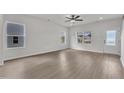 Spacious living room featuring large windows offering plenty of natural light and a ceiling fan at 503 Benton Dr, Oxford, NC 27565