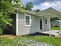 The side exterior features a covered front porch, neat landscaping, and neutral siding, showcasing a well-maintained home at 511 Commonwealth St, Durham, NC 27703