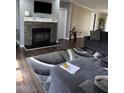 Inviting living room featuring a stone fireplace and comfortable seating on modern wood floors at 57 Winding Ridge Rdg, Sanford, NC 27332