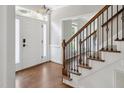 Inviting entryway with hardwood floors, staircase, and natural light, offering a warm welcome at 5809 N Hawthorne Way, Raleigh, NC 27603