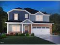 Charming two-story home with brick and siding, features a two-car garage and landscaped front yard at 760 Deschutes Dr, Garner, NC 27529