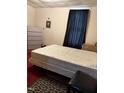 Bedroom with carpet, a window with dark curtains, and a large mattress at 911 Holloway St, Durham, NC 27701